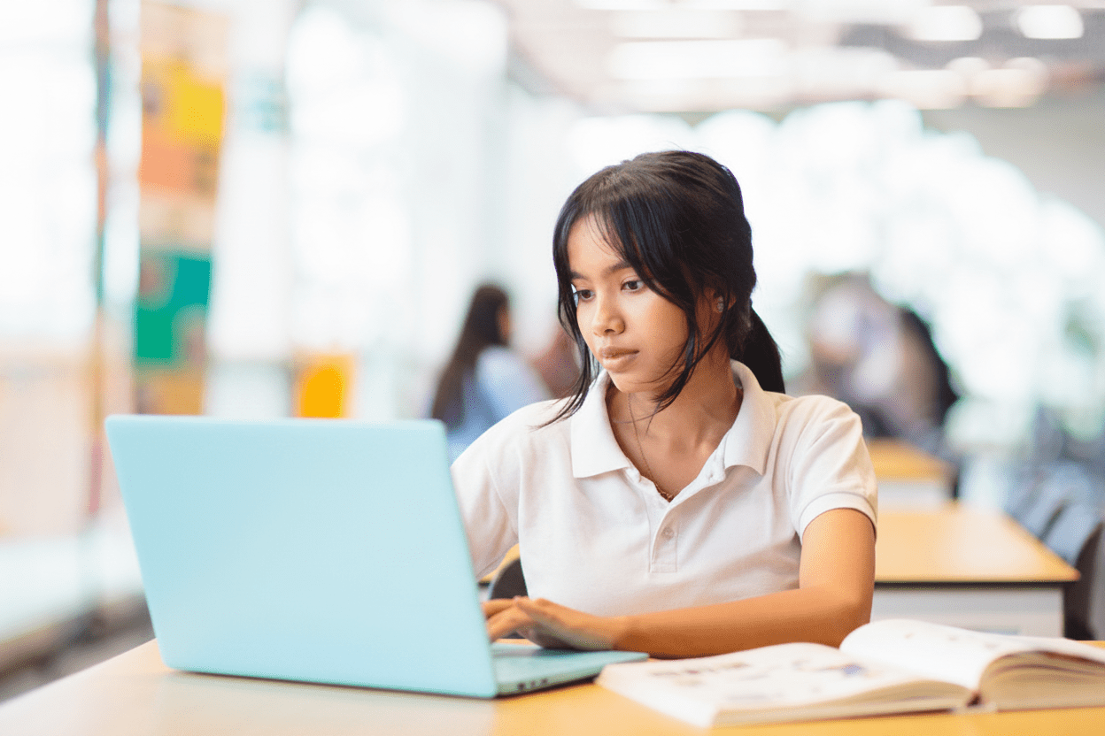 girl with laptop in library